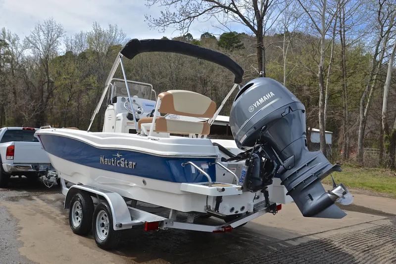 Slide: The Image of 2023 NauticStar 211 Hybrid boat on trailer with Yamaha outboard motor. - 12