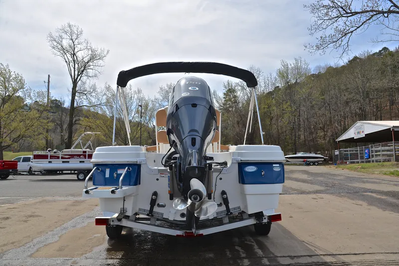 Slide: The Image of 2023 NauticStar 211 Hybrid boat, rear view, parked on a trailer, outdoor setting. - 13