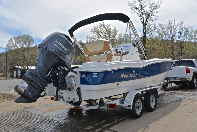 Slide: The Image of 2023 NauticStar 211 Hybrid boat on trailer with Yamaha outboard motor. - 14