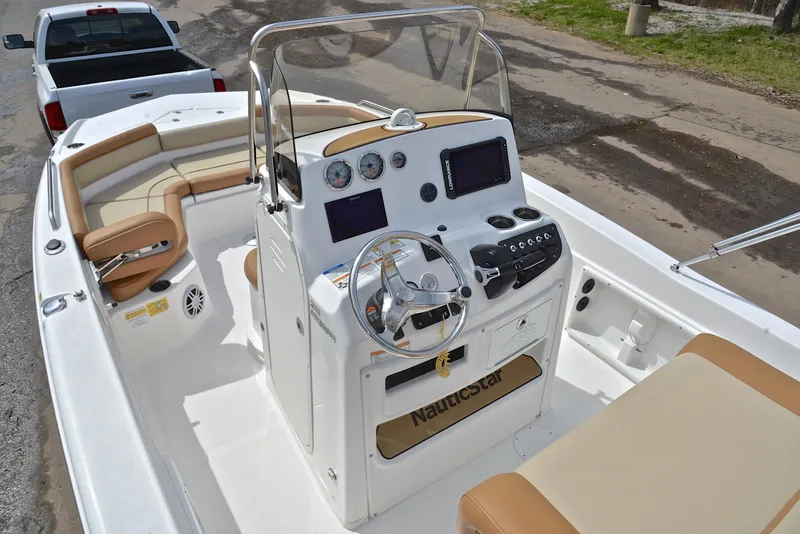 Slide: The Image of 2023 NauticStar 211 Hybrid boat interior with steering console and seating. - 20