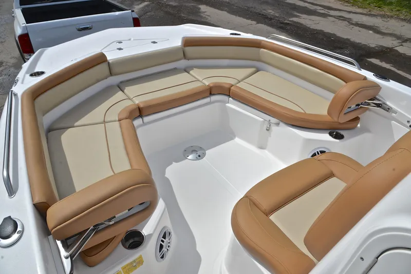 Slide: The Image of 2023 NauticStar 211 Hybrid boat with tan and cream seating in the bow area. - 22