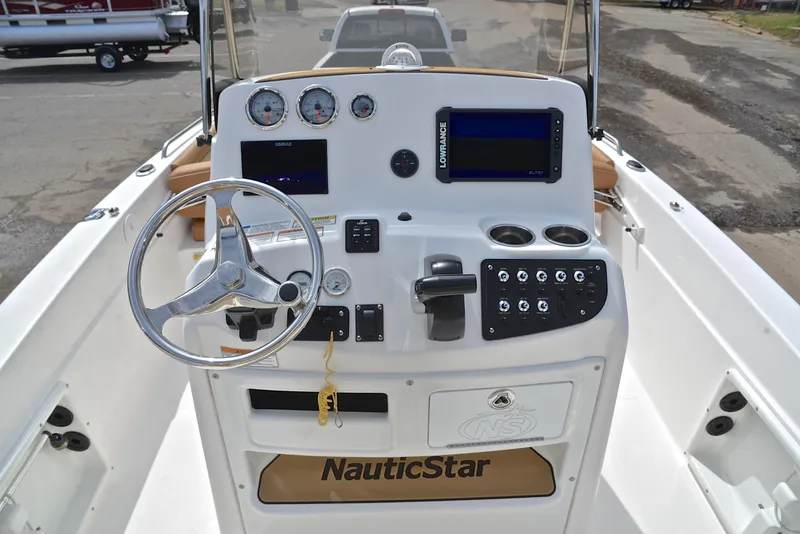 Slide: The Image of 2023 NauticStar 211 Hybrid boat console with steering wheel, gauges, and controls. - 25