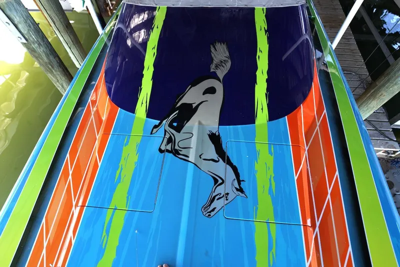 Slide: The Image of 2008 Outerlimits 39 Quattro boat with vibrant, colorful design and animal graphic. - 15