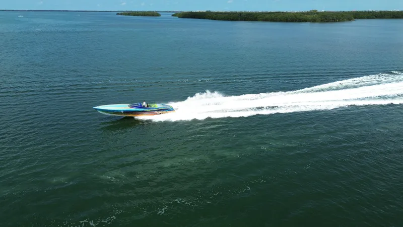 Slide: The Image of 2008 Outerlimits 39 Quattro speedboat cruising on open water, leaving a white wake trail. - 2