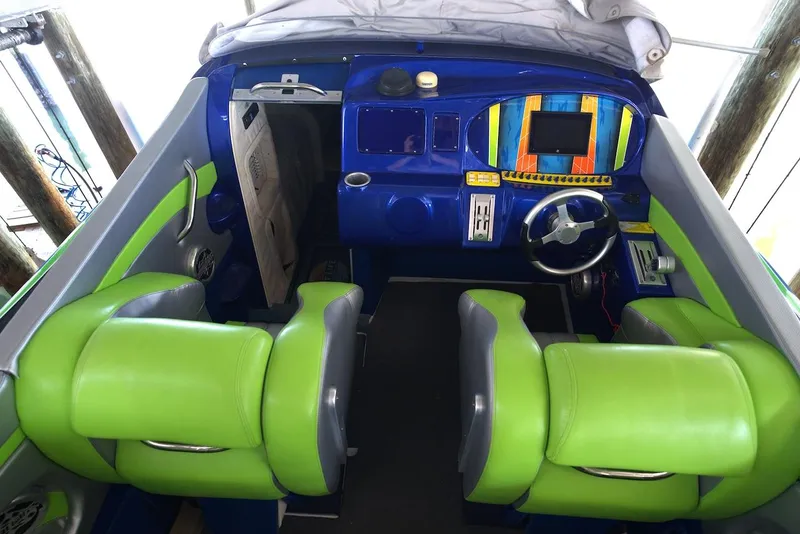 Slide: The Image of 2008 Outerlimits 39 Quattro cockpit with vibrant green and blue seating and dashboard. - 24