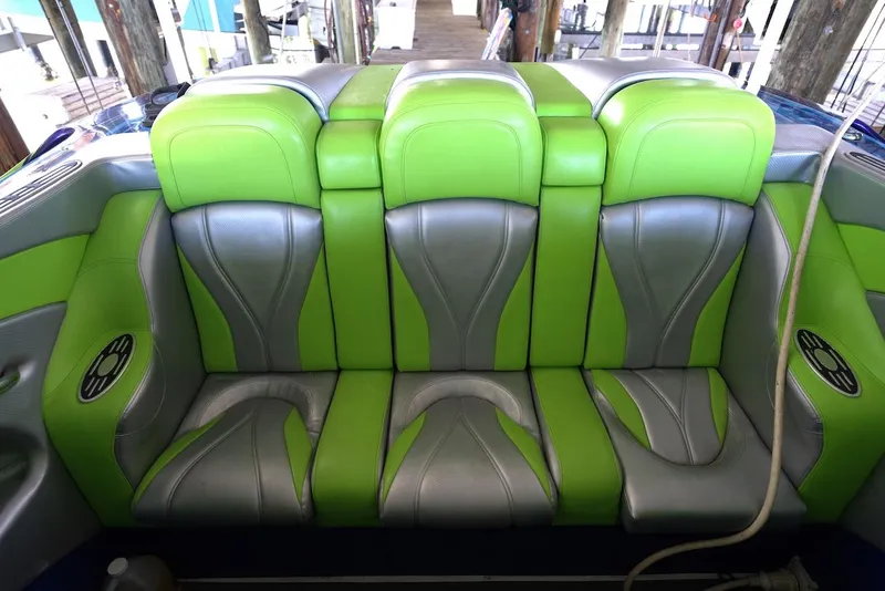 Slide: The Image of 2008 Outerlimits 39 Quattro boat seats, green and gray upholstery, docked setting. - 26
