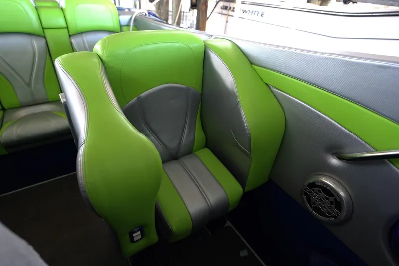 Slide: The Image of 2008 Outerlimits 39 Quattro boat interior with green and gray seating. - 28