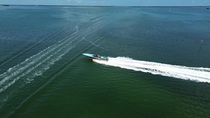 Slide: The Image of 2008 Outerlimits 39 Quattro speedboat cruising on open water, leaving a white wake trail. - 3