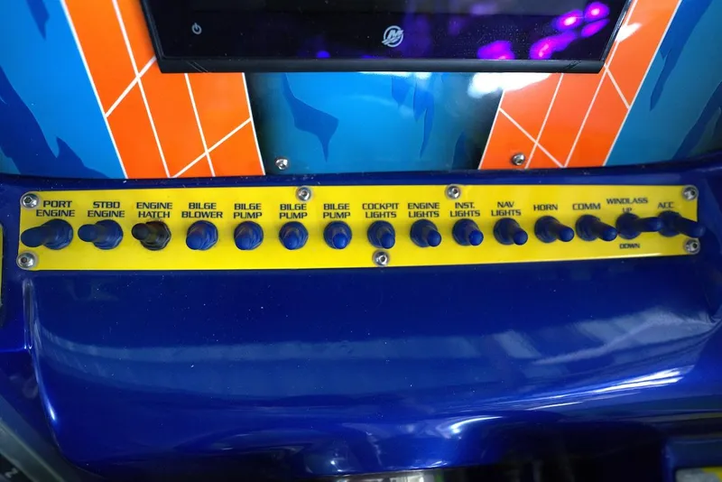 Slide: The Image of Control panel of a 2008 Outerlimits 39 Quattro boat with labeled switches. - 30