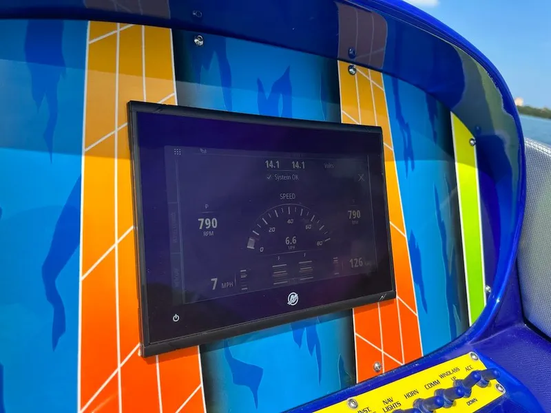 Slide: The Image of Dashboard of 2008 Outerlimits 39 Quattro boat with vibrant, colorful design. - 32