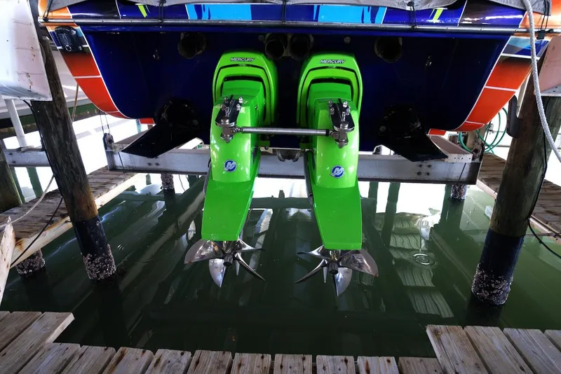 Slide: The Image of 2008 Outerlimits 39 Quattro boat with vibrant green dual outboard motors. - 34