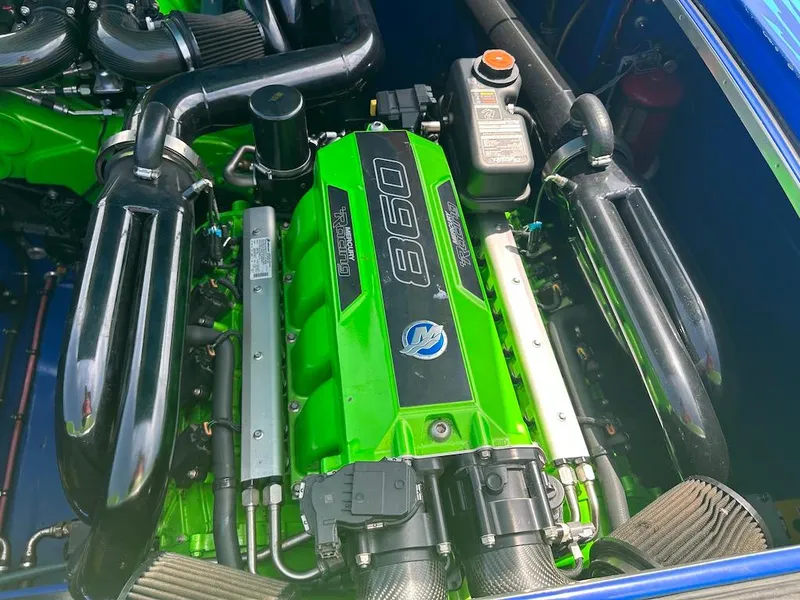 Slide: The Image of Engine of a 2008 Outerlimits 39 Quattro boat, featuring vibrant green components. - 35