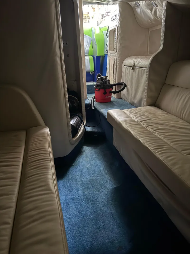 Slide: The Image of Interior of a 2008 Outerlimits 39 Quattro boat with beige seating and blue carpet. - 38