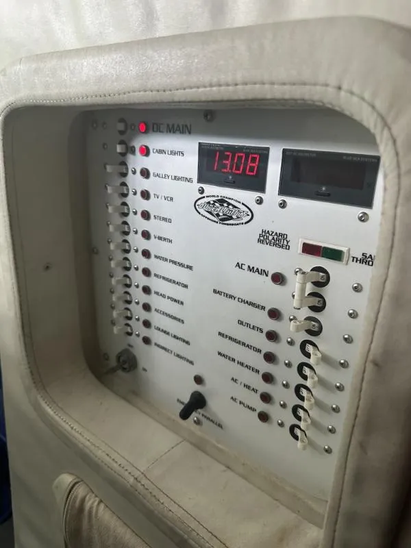 Slide: The Image of Control panel of a 2008 Outerlimits 39 Quattro boat with various switches and indicators. - 40