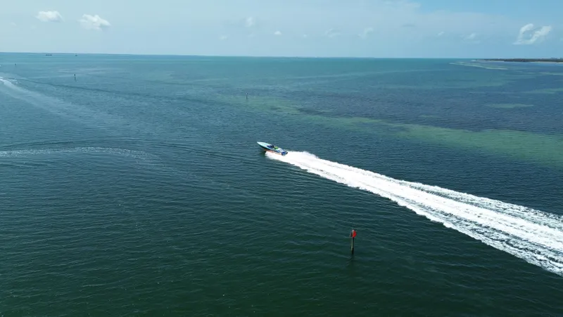 Slide: The Image of Aerial view of 2008 Outerlimits 39 Quattro speedboat cruising on open water. - 5