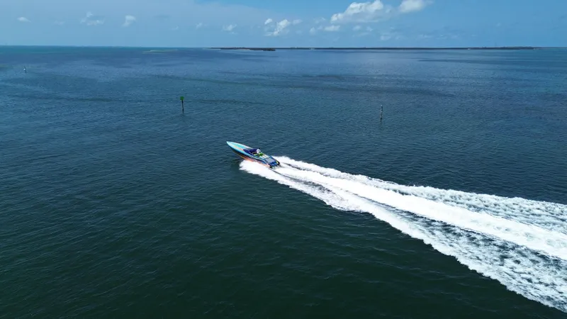 Slide: The Image of 2008 Outerlimits 39 Quattro speedboat cruising on open water under a clear blue sky. - 6