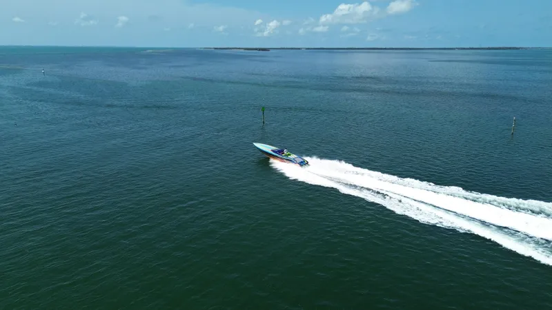 Slide: The Image of 2008 Outerlimits 39 Quattro speedboat cruising on open water under a clear sky. - 7