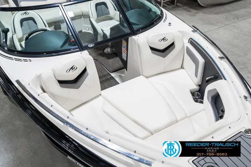 Slide: The Image of 2013 Monterey 232 SS boat interior with white seating and sleek design. - 13