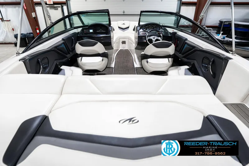 Slide: The Image of 2013 Monterey 232 SS boat interior with white seating and modern dashboard. - 16