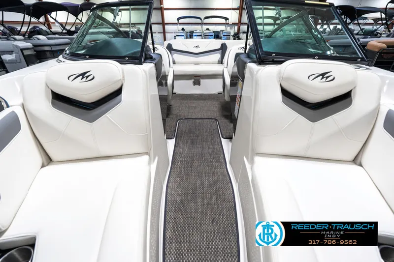 Slide: The Image of 2013 Monterey 232 SS boat interior with white seating and carpeted flooring. - 19