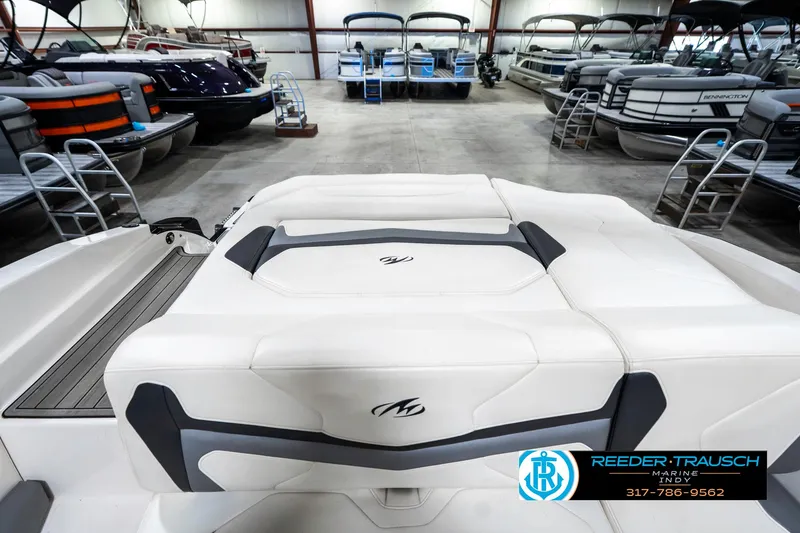 Slide: The Image of 2013 Monterey 232 SS boat interior in showroom with other boats. - 21