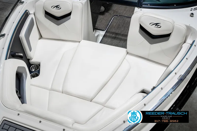 Slide: The Image of 2013 Monterey 232 SS boat interior with white cushioned seating and cup holders. - 22