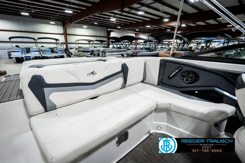 Slide: The Image of 2013 Monterey 232 SS boat interior with white seating in a showroom. - 31