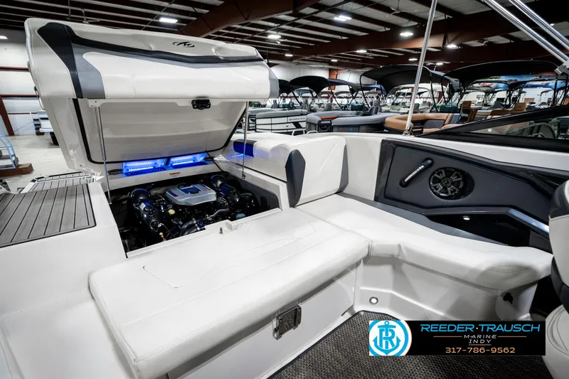 Slide: The Image of 2013 Monterey 232 SS boat interior with open engine compartment in showroom. - 32