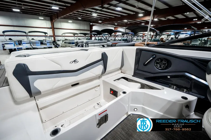 Slide: The Image of Interior of 2013 Monterey 232 SS boat in showroom, featuring seating and control panel. - 33