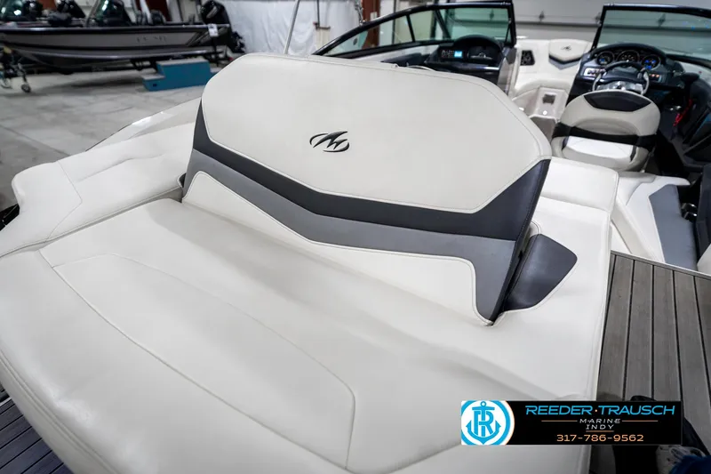Slide: The Image of 2013 Monterey 232 SS boat interior with white and gray seating, Reeder-Trausch logo visible. - 35