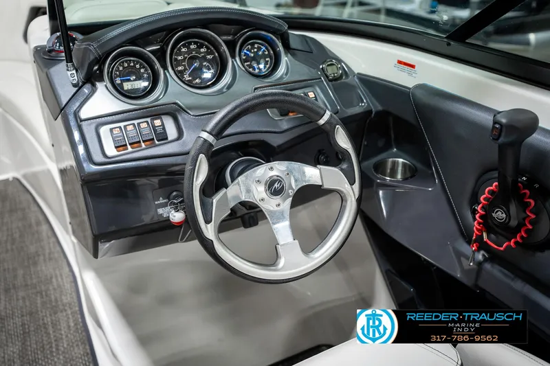 Slide: The Image of 2013 Monterey 232 SS boat dashboard with steering wheel and instrument panel. - 37