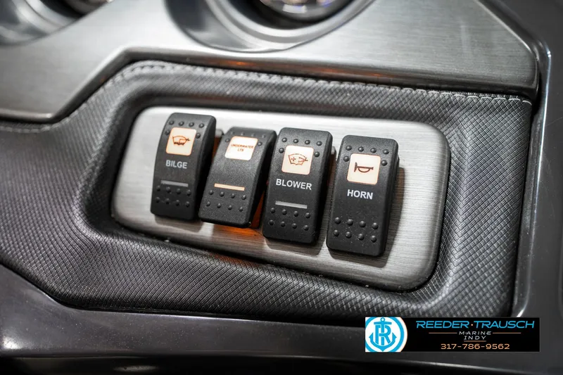 Slide: The Image of Control panel of a 2013 Monterey 232 SS boat with bilge, blower, and horn switches. - 44