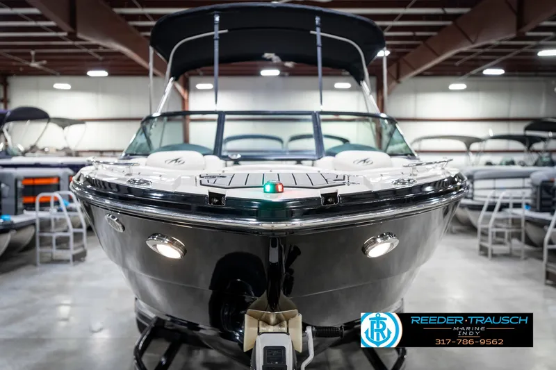 Slide: The Image of 2013 Monterey 232 SS boat in showroom, front view, with Reeder-Trausch Marine logo. - 5