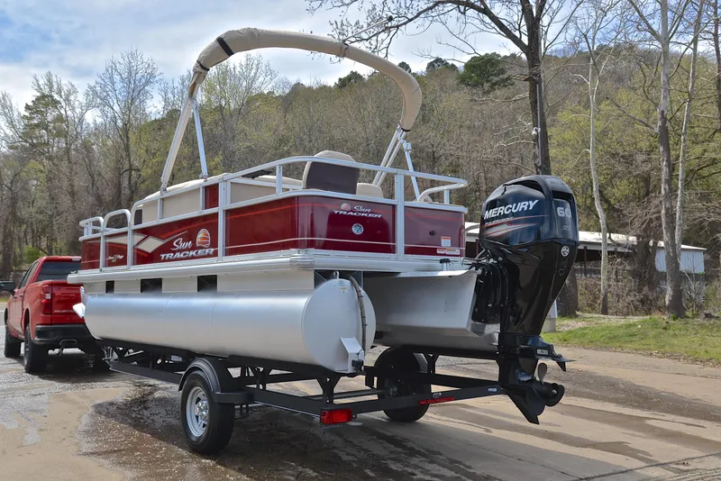 Slide: The Image of 2018 Sun Tracker Bass Buggy 18 DLX pontoon boat with Mercury engine on trailer. - 12