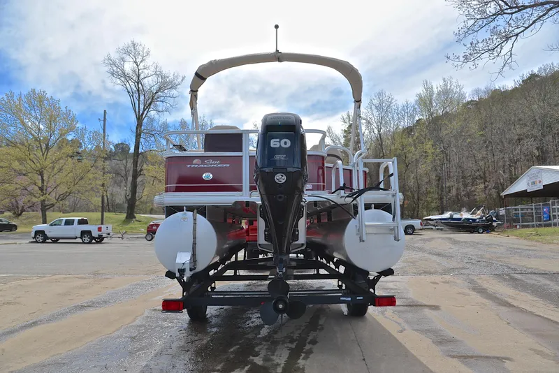 Slide: The Image of 2018 Sun Tracker Bass Buggy 18 DLX pontoon boat with 60 HP Mercury engine, parked outdoors. - 13