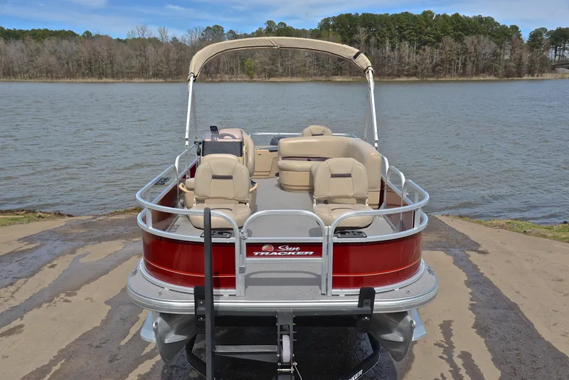 Slide: The Image of 2018 Sun Tracker Bass Buggy 18 DLX pontoon boat on a lake shore. - 17