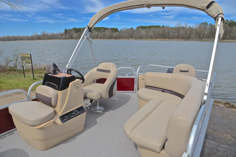 Slide: The Image of 2018 Sun Tracker Bass Buggy 18 DLX pontoon boat on a serene lake. - 21