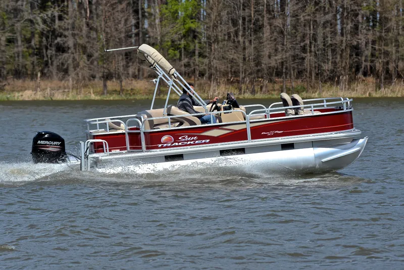 Slide: The Image of 2018 Sun Tracker Bass Buggy 18 DLX pontoon boat cruising on a lake. - 3