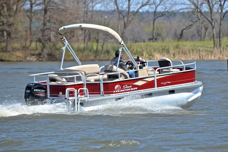 Slide: The Image of 2018 Sun Tracker Bass Buggy 18 DLX pontoon boat cruising on a lake. - 5