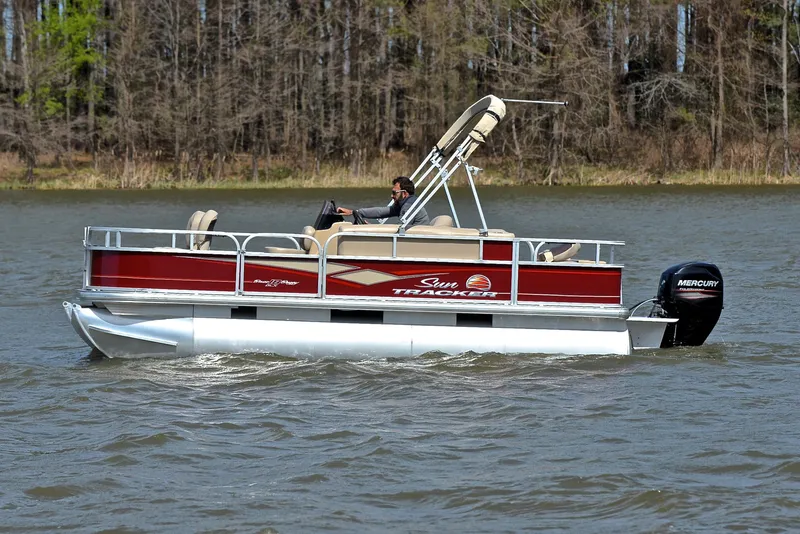 Slide: The Image of 2018 Sun Tracker Bass Buggy 18 DLX pontoon boat cruising on a lake. - 8