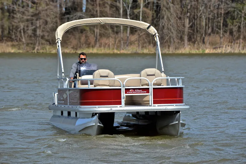 Slide: The Image of 2018 Sun Tracker Bass Buggy 18 DLX pontoon boat cruising on a lake. - 9