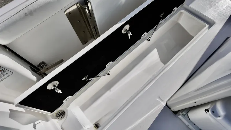 Slide: The Image of 2025 Sea Fox 288 Commander storage compartment with open lid and secure latches. - 14