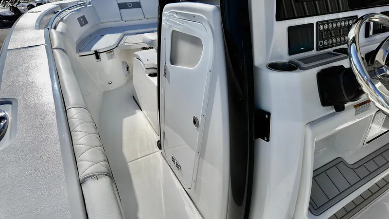 Slide: The Image of 2025 Sea Fox 288 Commander boat interior with sleek white seating and modern control panel. - 17