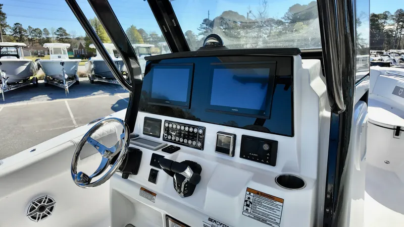 Slide: The Image of 2025 Sea Fox 288 Commander dashboard with dual screens and steering wheel. - 6