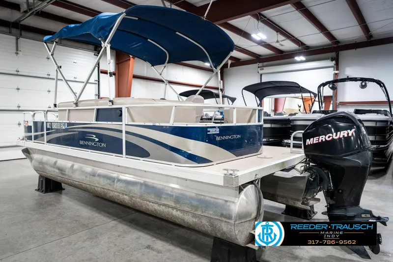 Slide: The Image of 2011 Bennington 20 SFI pontoon boat with Mercury outboard in indoor showroom. - 10