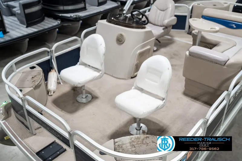 Slide: The Image of 2011 Bennington 20 SFI pontoon boat interior with white seating and steering console. - 12