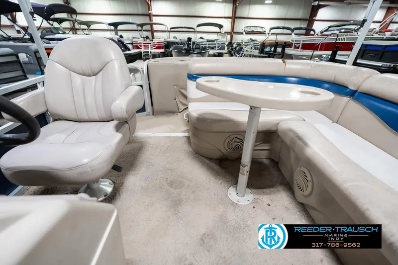 Slide: The Image of 2011 Bennington 20 SFI boat interior with seating and table, displayed in a showroom. - 17