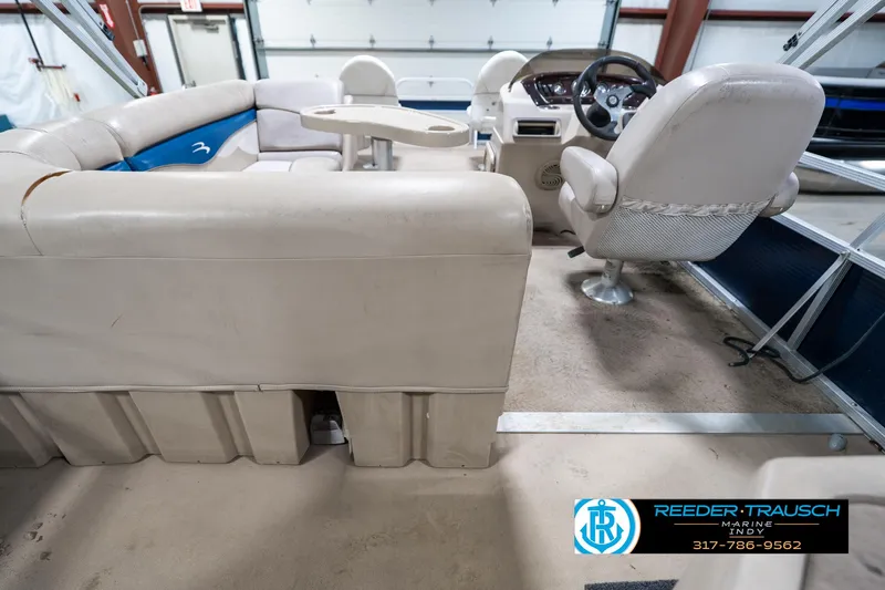 Slide: The Image of 2011 Bennington 20 SFI boat interior with beige seating and steering wheel. - 19