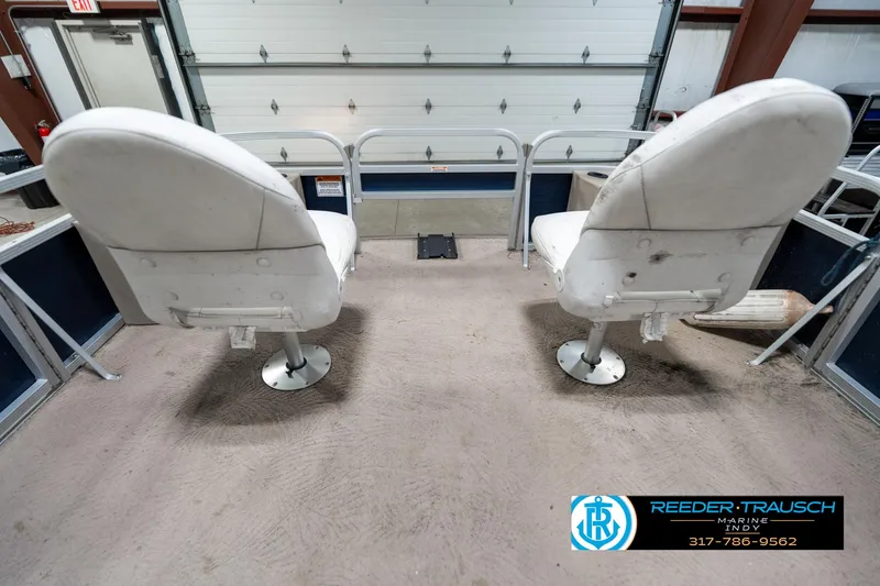 Slide: The Image of 2011 Bennington 20 SFI boat interior with two white swivel seats. - 21