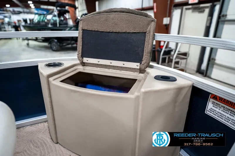 Slide: The Image of Open storage compartment on a 2011 Bennington 20 SFI boat, featuring cup holders. - 23